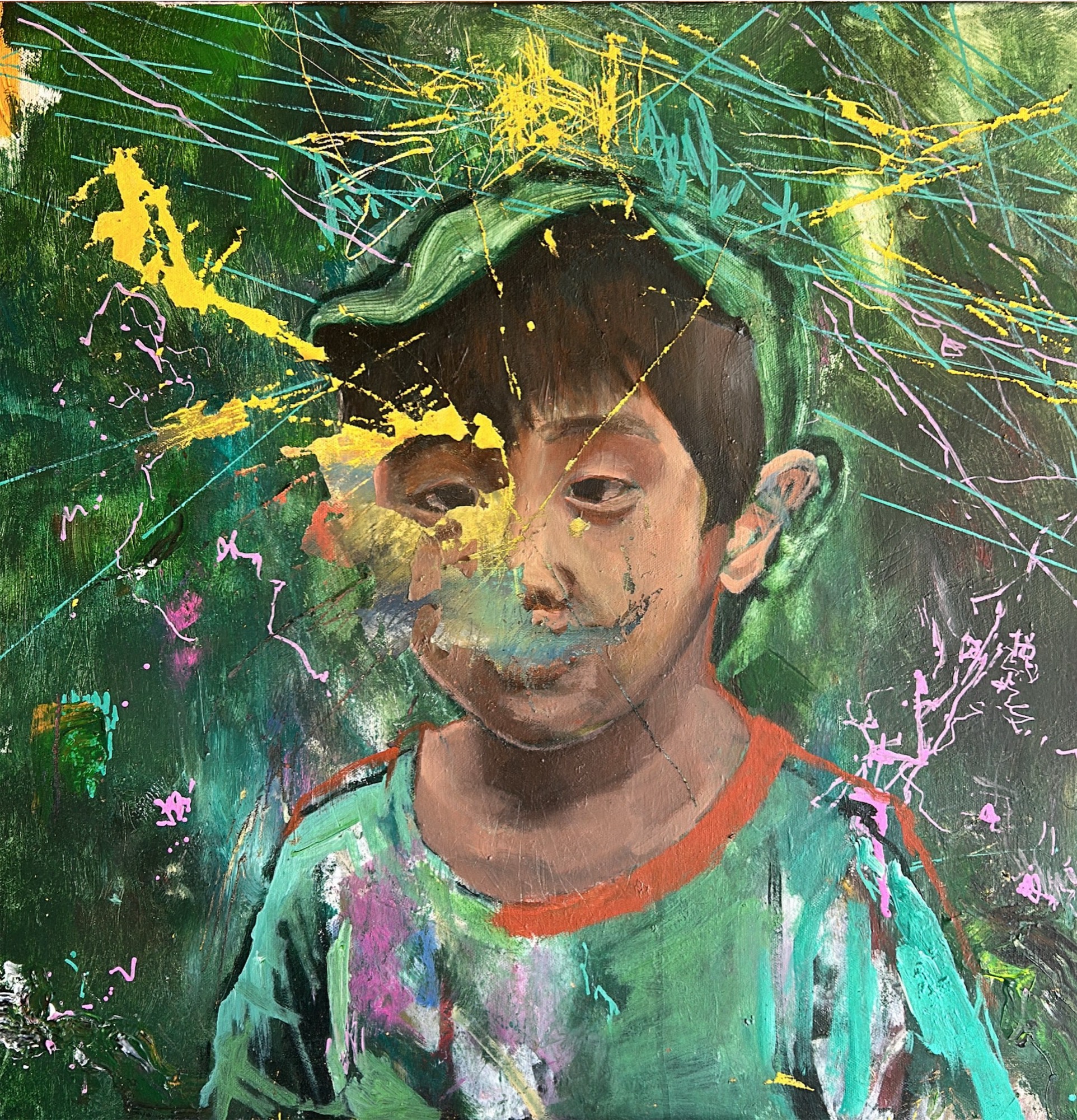 Boy portrait with paint splatters on green ground