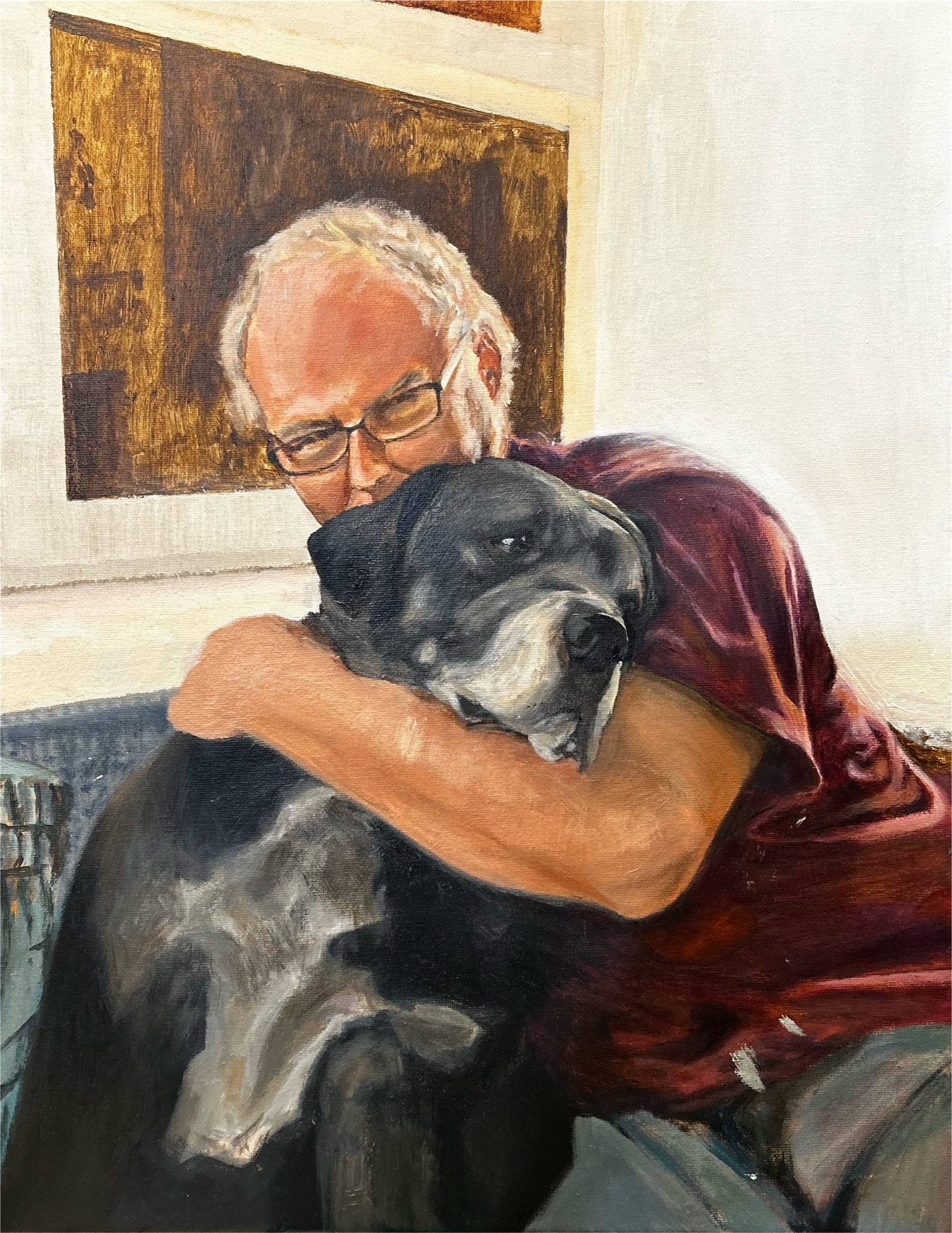 Man embracing grey dog